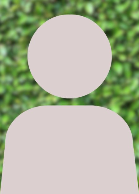 A grey person silhouette in front of blurred greenery.