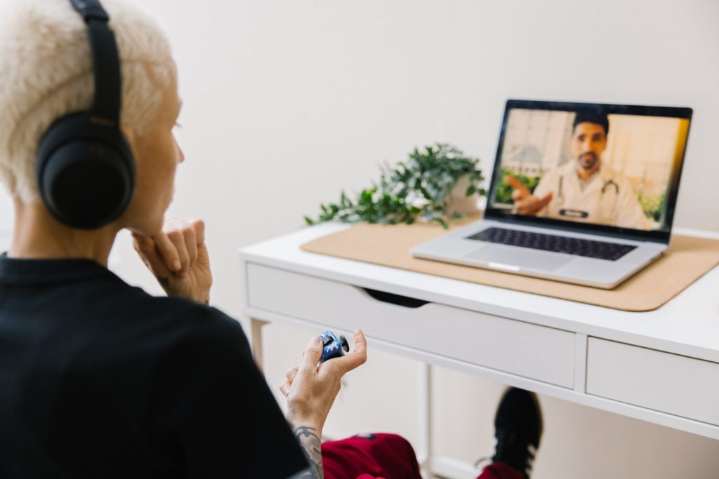 A person on a telehealth video call with a doctor.