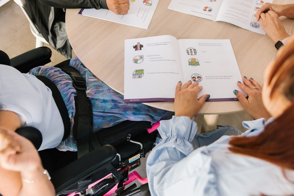 Top view of people looking at documents on a table.