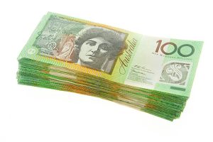 Photograph of a large stack of Australian $100 notes.
