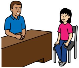 Cartoon drawing of a man with brown hair sitting at a desk. A young woman with black hair is sitting on a chair facing the man.