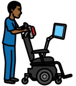 Cartoon drawing of a man with black hair standing behind an empty wheelchair. He is touching the headrest of the wheelchair.