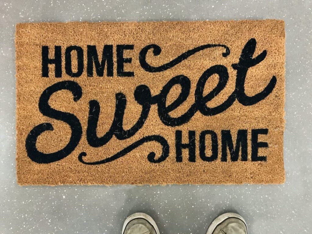A brown doormat with the words "Home sweet home"