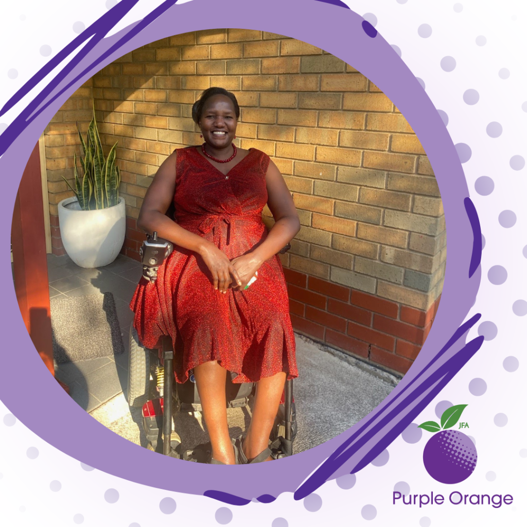 Light purple spotted background with circular dark purple accent around a photo of Esther, wearing a red dress and seated on her walker, smiling at the camera.