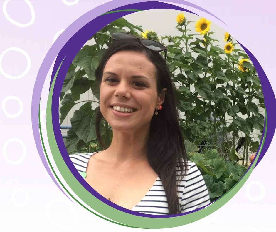 Ayla smiles at the camera. She is wearing a striped top, sunglasses on her head, and is standing in front of tall sunflowers, framed by purple and green circular graphics.